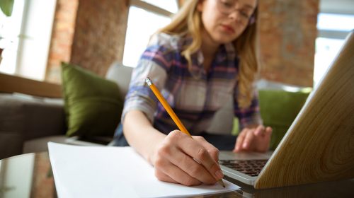 Individual writing answers to a quiz